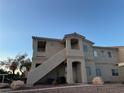 Apartment complex exterior featuring stucco construction, open stairways, and well-maintained landscaping at 1881 W Alexander Rd # 2095, North Las Vegas, NV 89032