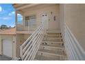 Exterior shot of staircase leading to the entrance of a residential unit. White railings accent the sandstone steps at 1900 N Torrey Pines Dr # 216, Las Vegas, NV 89108