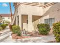 Well-manicured exterior with mature landscaping, walkway, and detailed entry door at 2109 Echo Bay St # 104, Las Vegas, NV 89128