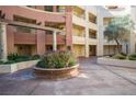 Condo courtyard featuring mature landscaping with planter, architectural details, and walkways at 220 E Flamingo Rd # 129, Las Vegas, NV 89169