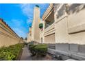 Exterior view of a well-maintained condo with a stucco facade and manicured shrubs at 2251 Wigwam Pkwy # 923, Henderson, NV 89074