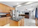 Bright, open kitchen leading into the living room featuring stainless steel appliances and a spacious center island at 2445 Rue Royale, Henderson, NV 89044