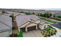 Aerial view showcases a well-maintained single-Gathering home with a tile roof and desert landscaping at 2539 Ballatore St, Henderson, NV 89044