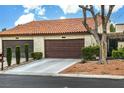 Charming single-story home featuring brown garage doors, stucco walls, and a red tile roof at 3053 Conquista Ct, Las Vegas, NV 89121