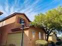 Inviting two-story home with a two-car garage, a charming tree, and plenty of curb appeal at 3525 Hammock St, Las Vegas, NV 89147