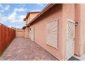 Side exterior showing a long walkway with brick pavers and security doors with sunburst design at 3744 Archer St, Las Vegas, NV 89108