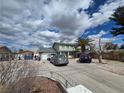 Two-story home with mature trees, a long driveway, and a two-car garage beneath cloudy skies at 4342 E Russell Rd, Las Vegas, NV 89120