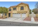 Inviting two-story home featuring a two-car garage, desert landscaping, and classic stucco exterior at 4416 Dunlap Crossing St, Las Vegas, NV 89129