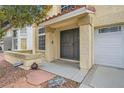 Inviting front porch with stone details and a security door, leading to an attached garage at 4416 Dunlap Crossing St, Las Vegas, NV 89129