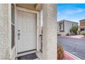 Welcoming front door with security features and a covered porch, offering a secure entrance at 5246 Aurora Beam Ave, Las Vegas, NV 89122