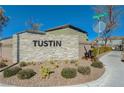 Welcome to Tustin, an inviting community entrance featuring stone signage and well-maintained landscaping at 5691 Tinar St, Las Vegas, NV 89113