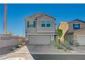 This two-story residence features an attached garage and well-maintained landscaping adding curb appeal at 5691 Tinar St, Las Vegas, NV 89113