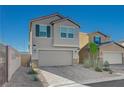 Two-story home showcasing a neutral exterior, two-car garage, and professionally landscaped front yard at 5691 Tinar St, Las Vegas, NV 89113