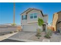 Two-story home showcasing desert landscaping, brick driveway, neutral color scheme and spacious garage at 5691 Tinar St, Las Vegas, NV 89113