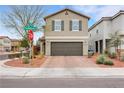 Inviting two-story home with a brown two-car garage, desert landscaping, and a well-maintained front yard at 6619 Frosted Harvest Ave, Las Vegas, NV 89108