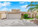 Charming home featuring a two-car garage, manicured lawn, and mature landscaping at 738 Panhandle Dr, Henderson, NV 89014