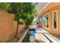 Serene backyard patio featuring a water feature and access to the golf course at 7711 Spanish Lake Dr, Las Vegas, NV 89113