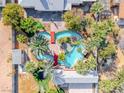 Aerial view of private backyard with a unique pool, bridges, mature landscaping and adjacent single-story home at 7748 Firethorn Ln, Las Vegas, NV 89123