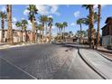 Palm tree lined community entrance with decorative brick drive at 8000 Badura Ave # 1007, Las Vegas, NV 89113