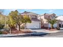 Inviting two-story home boasts a spacious driveway and desert-friendly yard at 8005 Dover Shores Ave, Las Vegas, NV 89128