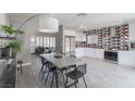 Modern dining area open to kitchen featuring a large table and stylish decor at 8198 Palmada Dr, Las Vegas, NV 89123