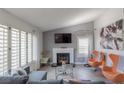 Bright living room with fireplace, stylish seating, and ample natural light through shutters at 8198 Palmada Dr, Las Vegas, NV 89123