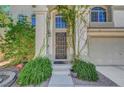 Inviting front entrance with lush greenery and a decorative security screen door at 8633 Radiant Ruby Ave, Las Vegas, NV 89143