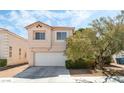 Charming two-story home showcasing a well-maintained exterior, two-car garage, and beautiful front yard landscaping at 8729 Country View Ave, Las Vegas, NV 89129