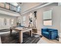 Bright living area with a pool table, high ceilings, statement art, and ample natural light at 9611 Trattoria St, Las Vegas, NV 89178