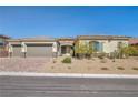 Inviting single-story home with a three-car garage and easy-care desert landscaping at 10062 Mountain Foothills Ave, Las Vegas, NV 89149