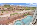Aerial view of backyard pool and jacuzzi featuring a small park, mountain, and neighborhood views at 10368 Pima Crossing Ave, Las Vegas, NV 89166