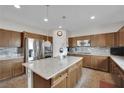 Modern kitchen featuring stainless steel appliances, granite countertops, and stylish lighting at 10368 Pima Crossing Ave, Las Vegas, NV 89166