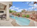 Relaxing backyard pool area with a jacuzzi and covered patio seating space at 10368 Pima Crossing Ave, Las Vegas, NV 89166