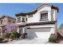 Charming two-story home featuring a manicured front yard and a two-car garage at 10783 Vestone St, Las Vegas, NV 89141