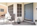 Inviting front porch featuring two chairs and a modern lantern at 10783 Vestone St, Las Vegas, NV 89141
