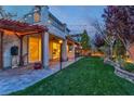 A backyard patio area with pavers, string lights, and a built-in outdoor kitchen perfect for entertaining at 10988 Wonder Hills St, Las Vegas, NV 89141