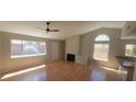 Spacious living room featuring hardwood floors, a fireplace and several windows bringing in natural light at 1163 Spanish Armada Rd, Las Vegas, NV 89123