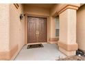 Inviting double front doors framed by stone columns add curb appeal at 1313 Gallery Oaks Dr, Las Vegas, NV 89123