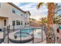 Inviting backyard pool and spa area with protective fencing, perfect for relaxation and entertainment at 1486 Neyland Dr, Henderson, NV 89012