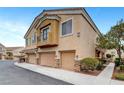 Inviting home boasting a three-car garage, neutral stucco exterior, and well-manicured landscaping at 1552 Wild Willey Way, Henderson, NV 89002