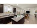 Open concept kitchen featuring granite countertops and views of the dining and living area at 168 Springhouse St, Las Vegas, NV 89148