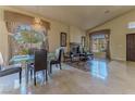Bright dining room with elegant chandelier and a view of the outdoors at 1720 Sand Storm Ct, Henderson, NV 89074