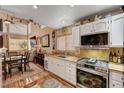 Well-lit kitchen boasts stainless steel appliances, granite countertops, and modern fixtures at 1721 Derbyshire Dr, Las Vegas, NV 89117