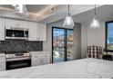 Modern kitchen with stainless steel appliances, quartz countertops, and a striking city view at 205 E Harmon Ave # 1010, Las Vegas, NV 89169