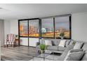 Cozy living room featuring comfortable seating and a stunning cityscape view through expansive windows at 205 E Harmon Ave # 1010, Las Vegas, NV 89169