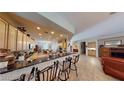 Expansive kitchen features granite counters, an island, and an eat-in breakfast bar at 2309 Aztec Ruin Way, Henderson, NV 89044