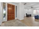 Inviting foyer boasts hardwood floors, natural light, and a view of a home office space at 26 Moraine Dr, Henderson, NV 89052