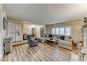 Spacious living room with a large sectional sofa, a comfortable recliner, and wood flooring at 2632 Matogroso Ln, Las Vegas, NV 89121