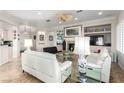 Bright living room with a fireplace, modern furnishings, and a ceiling fan at 2971 Fort Matanzas Ter, Henderson, NV 89052