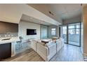 Open living room featuring tiled floors, high ceilings, concrete accent wall and a large window with natural light at 353 E Bonneville Ave # 125, Las Vegas, NV 89101